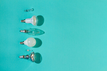 Different light bulbs: halogen, incandescent, LED, fluorescent on a blue background.
