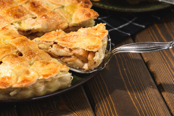 apple pie on a wooden background. Rustic style.