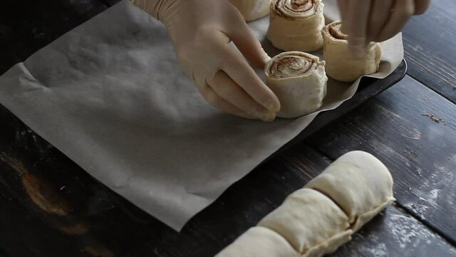 The process of making sweet cinnamon rolls. Cooking. Bakery products.