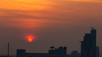 A blurred abstract background view of the rising sun, the horizon and the constantly blowing leaves of the trees, the ecological beauty that spontaneously occurs during the day.