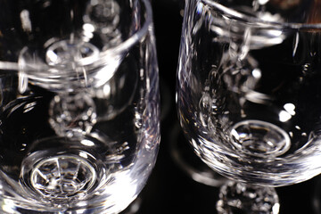 Vodka glasses on a black background. Closeup.