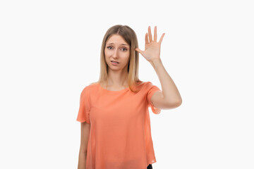 Portrait of annoyed blond girl rolling finger near temple, showing shock after hearing something...