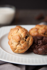 Cookies on a wooden table with a glass of milk