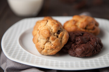 Cookies on a wooden table with a glass of milk