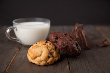 Cookies on a wooden table with a glass of milk