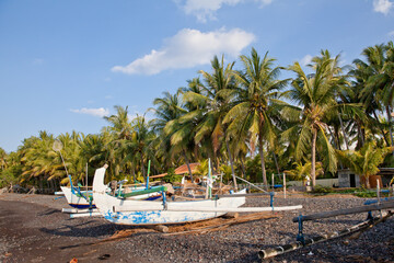 Fishing boats on the black sand. Bali island beach.