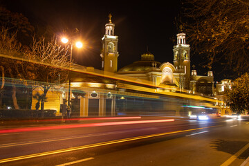 Fototapeta na wymiar Car and bus traffic lights on Baku street at night. Philarmonic Hall at night time