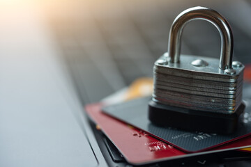 credit bank cards with a lock on the keyboard. Online shopping, online security. Hacking a bank...