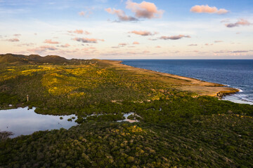 Aerial view above scenery of Curacao, Caribbean with ocean, coast, hills, lake