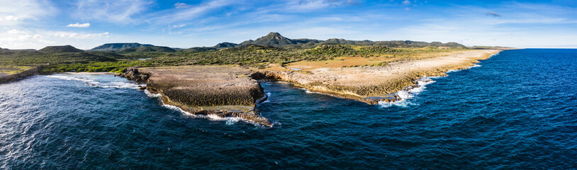 Aerial view above scenery of Curacao, Caribbean with ocean, coast, hills, lake