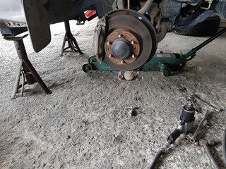 Close-up vehicle axle inspection, disc brake