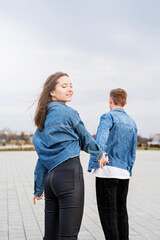 Fototapeta premium Young loving couple spending time together in the park having fun