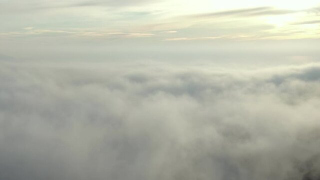 Clear composition from skies above and clouds at the bottom. Camera flight away from a horizont. And after making a hard stop. Aerial dron shot.