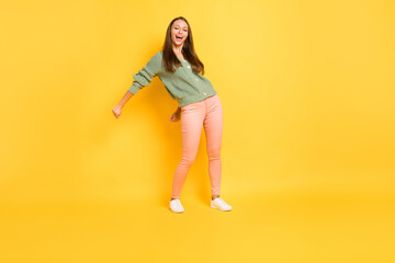 Fototapeta na wymiar Photo portrait full body view of girl doing modern dance flossing isolated on vivid yellow colored background
