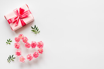 Valentines Day background with pink gift box and flowers