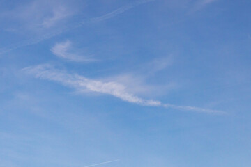 High white cirrus clouds with cirro-stratus in a light blue sky, sometimes called chair tails,...