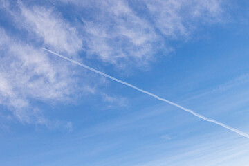 High white cirrus clouds with cirro-stratus in a light blue sky, sometimes called chair tails, indicate nice weather, but stormy changes come within a few days. Chemtrails on a blue sky