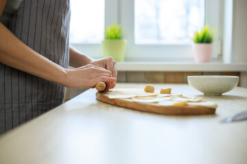 Obraz na płótnie Canvas Woman preparing rolling pin dough for traditional italian ravioli