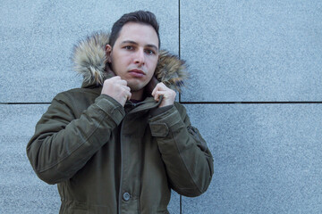 young man in coat on the city wall © tetxu