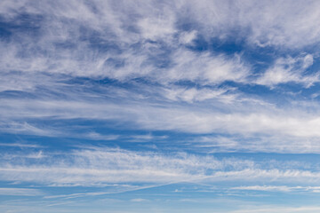 High white cirrus clouds with cirro-stratus in a light blue sky, sometimes called chair tails, indicate nice weather, but stormy changes come within a few days. White clouds in a blue sky. 
