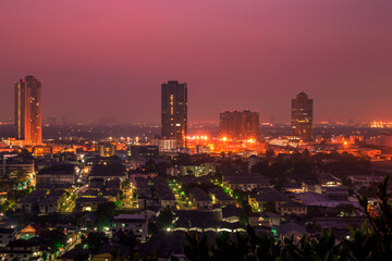 The high angle background of the city view with the secret light of the evening, blurring of night lights, showing the distribution of condominiums, dense homes in the capital community