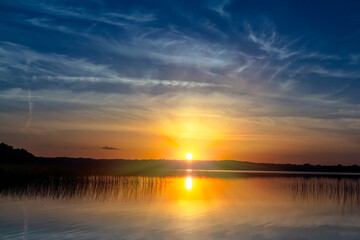 magical sunset over a lake in summer 