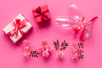 Valentines Day pattern of pink gift box and flowers. Overhead view
