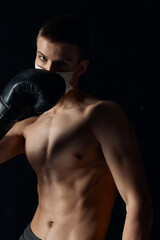 Obraz na płótnie Canvas boxer gloved naked torso muscle fitness black background circumcision