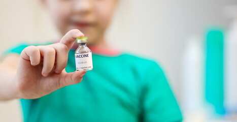 Close-up view of the vaccine in the child's hand, vaccination against covid-19, medical concept