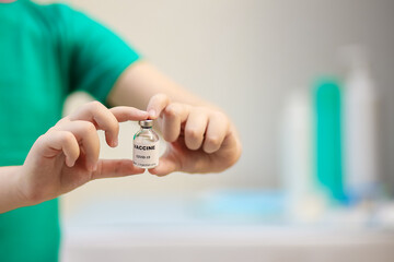 Close-up view of the vaccine in the hands of a child, vaccination against covid-19, medical concept