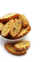 Traditional Italian Cantucci or Cantuccini cookies with almonds in a bowl isolated on white background