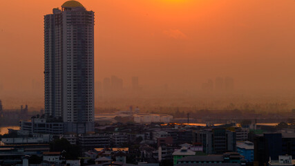 The high angle background of the city view with the secret light of the evening, blurring of night lights, showing the distribution of condominiums, dense homes in the capital community