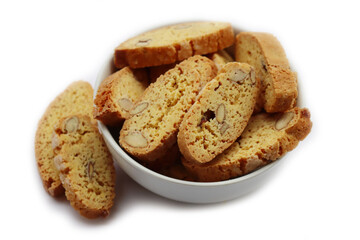 Traditional Italian Cantucci or Cantuccini cookies with almonds in a bowl isolated on white background