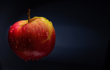 Red apple on a black background..