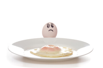 Egg and fried eggs on a plate..