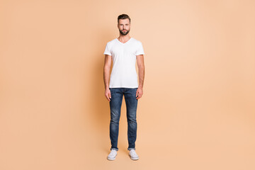Full body photo of young handsome man confident serious wear casual outfit isolated over beige color background