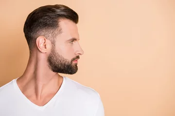 Fotobehang Kapsalon Profile side photo of young handsome bristle man confident look empty space isolated over beige color background  © deagreez