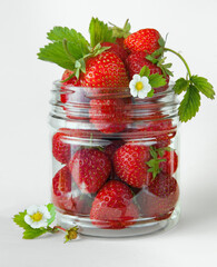 Berries fresh strawberries in a glass jar on a white background.