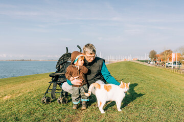 Man with toddler and cat on dyke