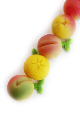 Traditional Italian Marzipan fruits isolated on white background. Sweet Marzipan shaped like fruits from Sicily