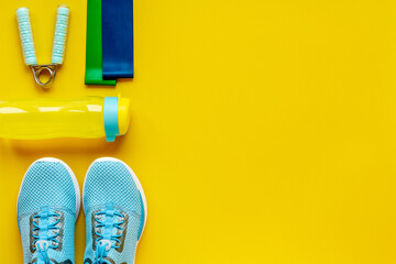 Fitness gym accessories with sneakers, top view