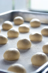 Fototapeta na wymiar pattern of donnut dough on bake sheet with white flour