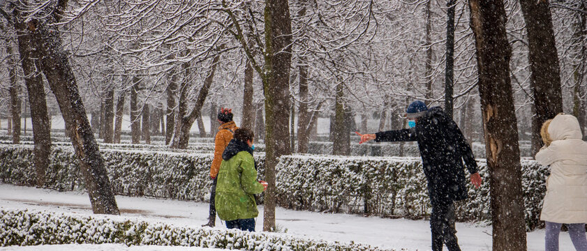 Two Children Walking Through A Snowstorm To Go To School