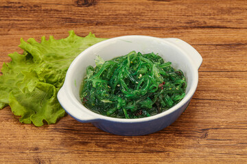 Green Chuka Seaweed Salad Isolated on White Background Top View. Wakame Sea Kelp Salat