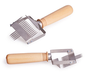Beekeeping fork (uncapping fork) for uncapping honeycomb isolated on a white background with clipping path. Beekeeping concept.