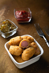 Mini corn dog with ketchup and jalapeno pepper