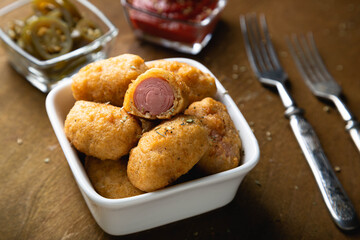 Mini corn dog with ketchup and jalapeno pepper