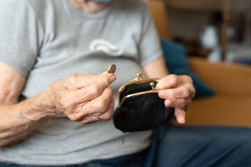 Hands of old person, senior holds wallet with money. Hands older woman calculate her small money....