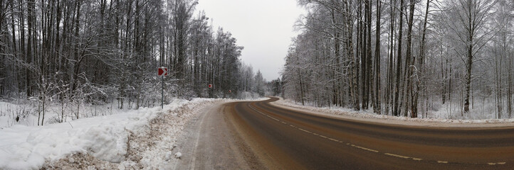 track winds through a snow covered forest treated with anti-icing agents
