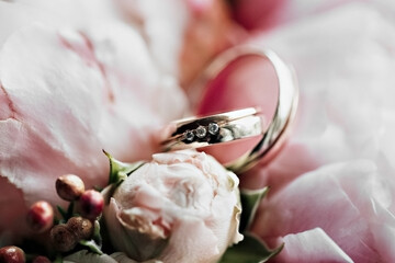 Wedding rings with a bouquet of flowers.Marriage proposal. Wedding